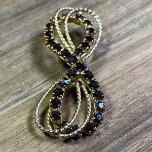 Gold tone and root beer glass Infinity brooch
